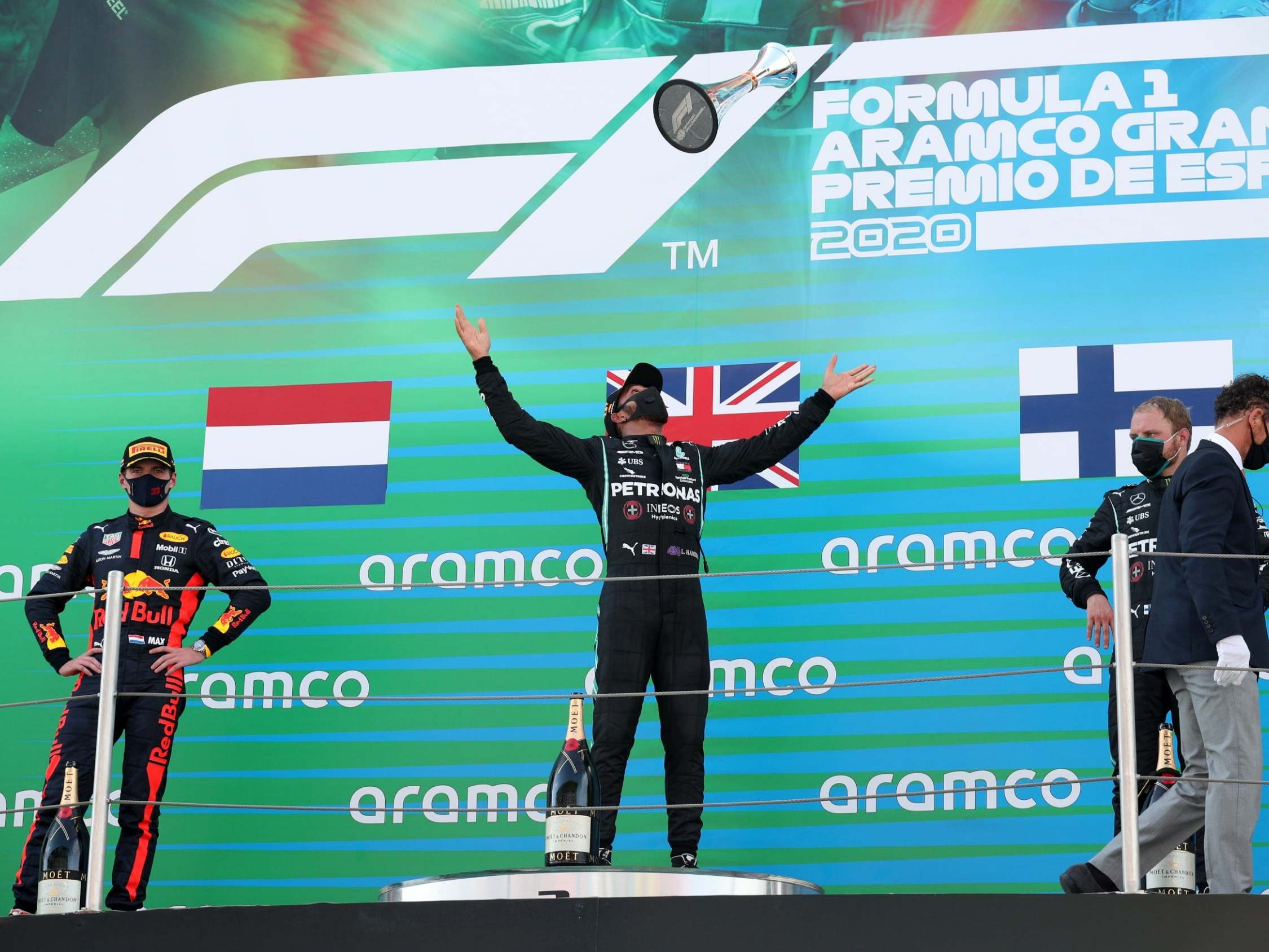Lewis Hamilton throws his trophy into the air in celebration of winning the Spanish Grand Prix