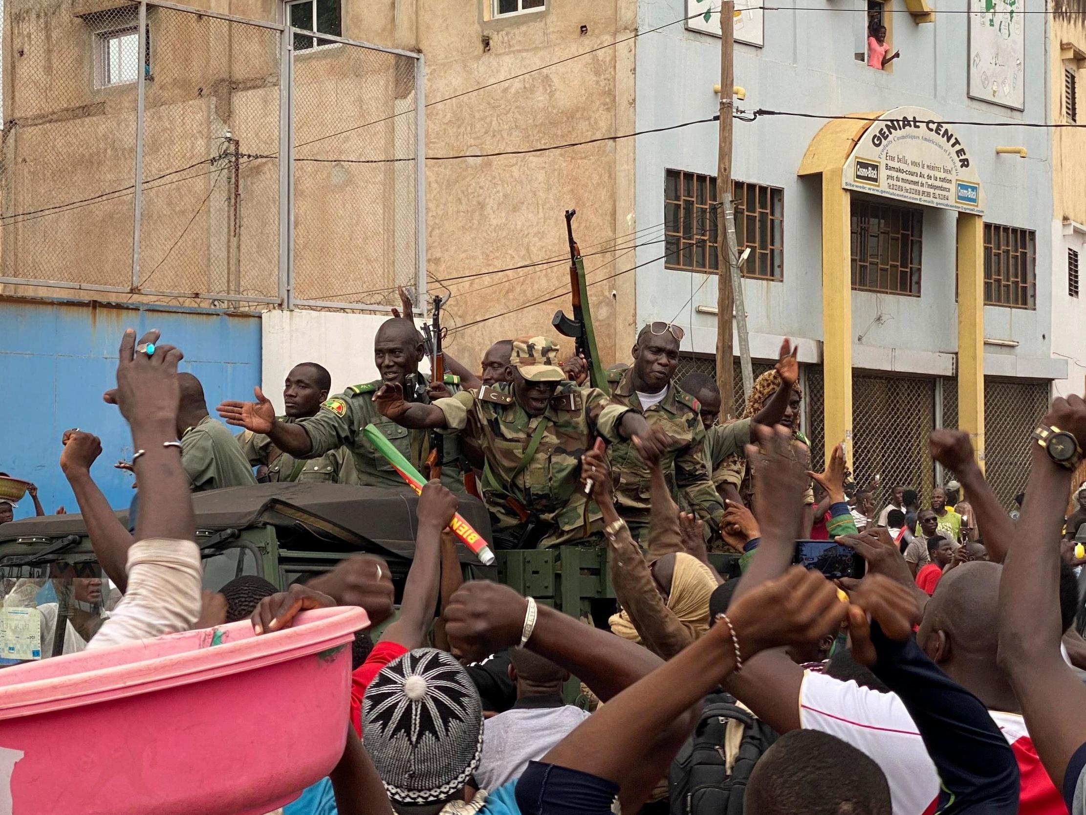 Malian soldiers are celebrated as they arrive at the Independence square in Bamako (AFP/Getty)