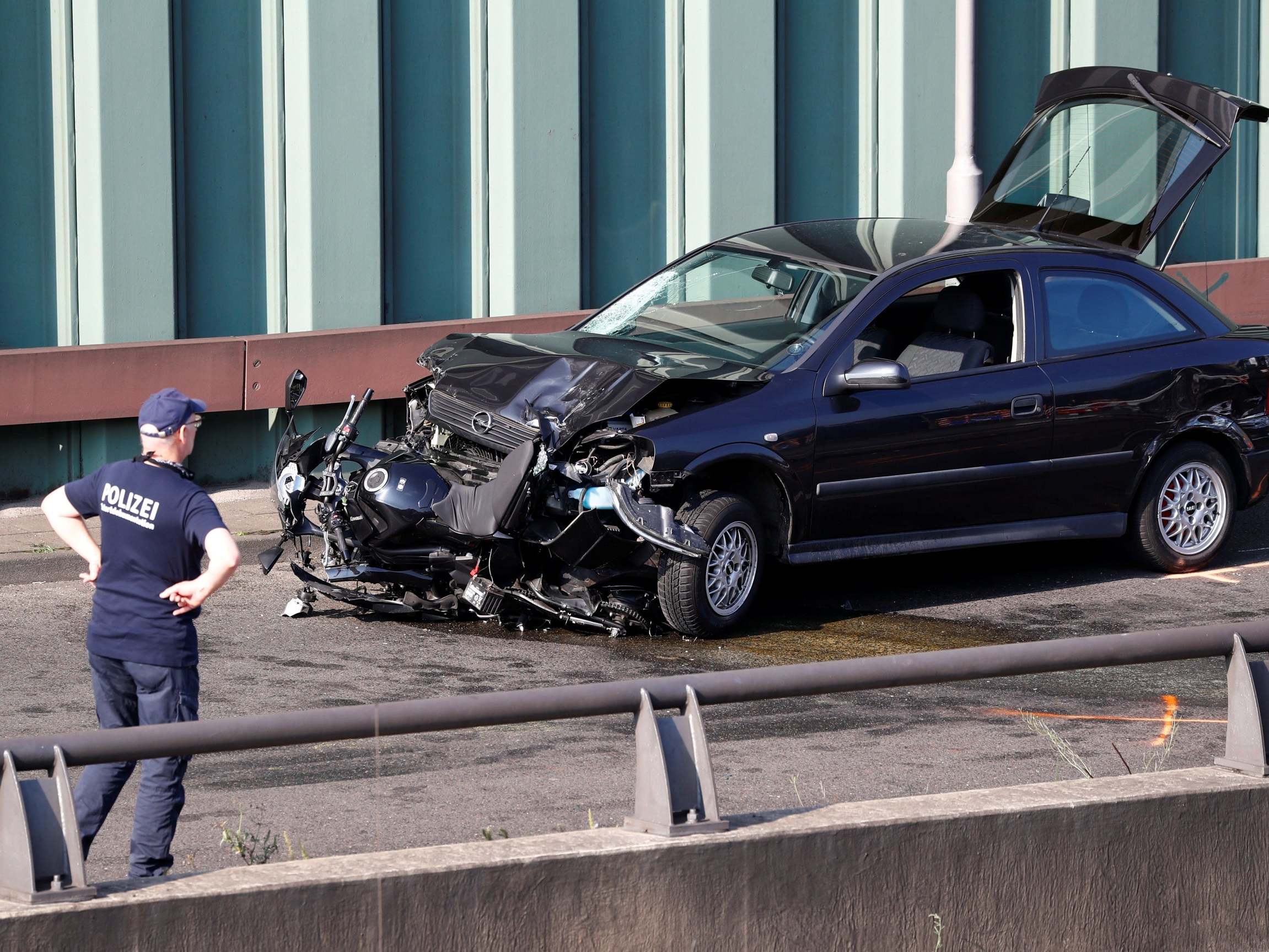 Police investigate the scene of a series of car crashes on highway A100 (Reuters)