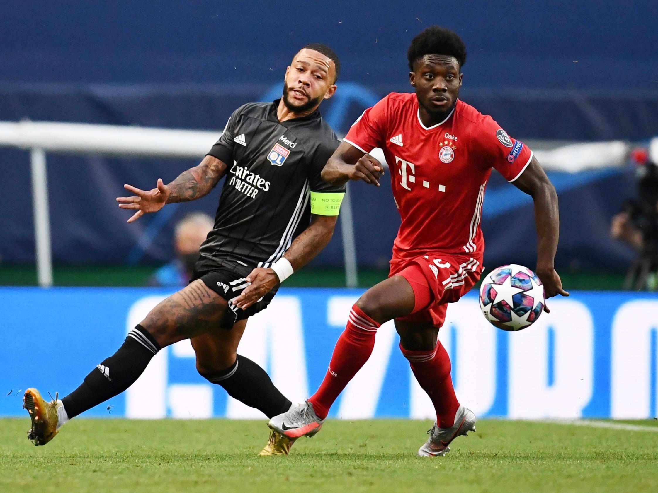 Olympique Lyonnais' Memphis Depay in action with Bayern Munich's Alphonso Davies