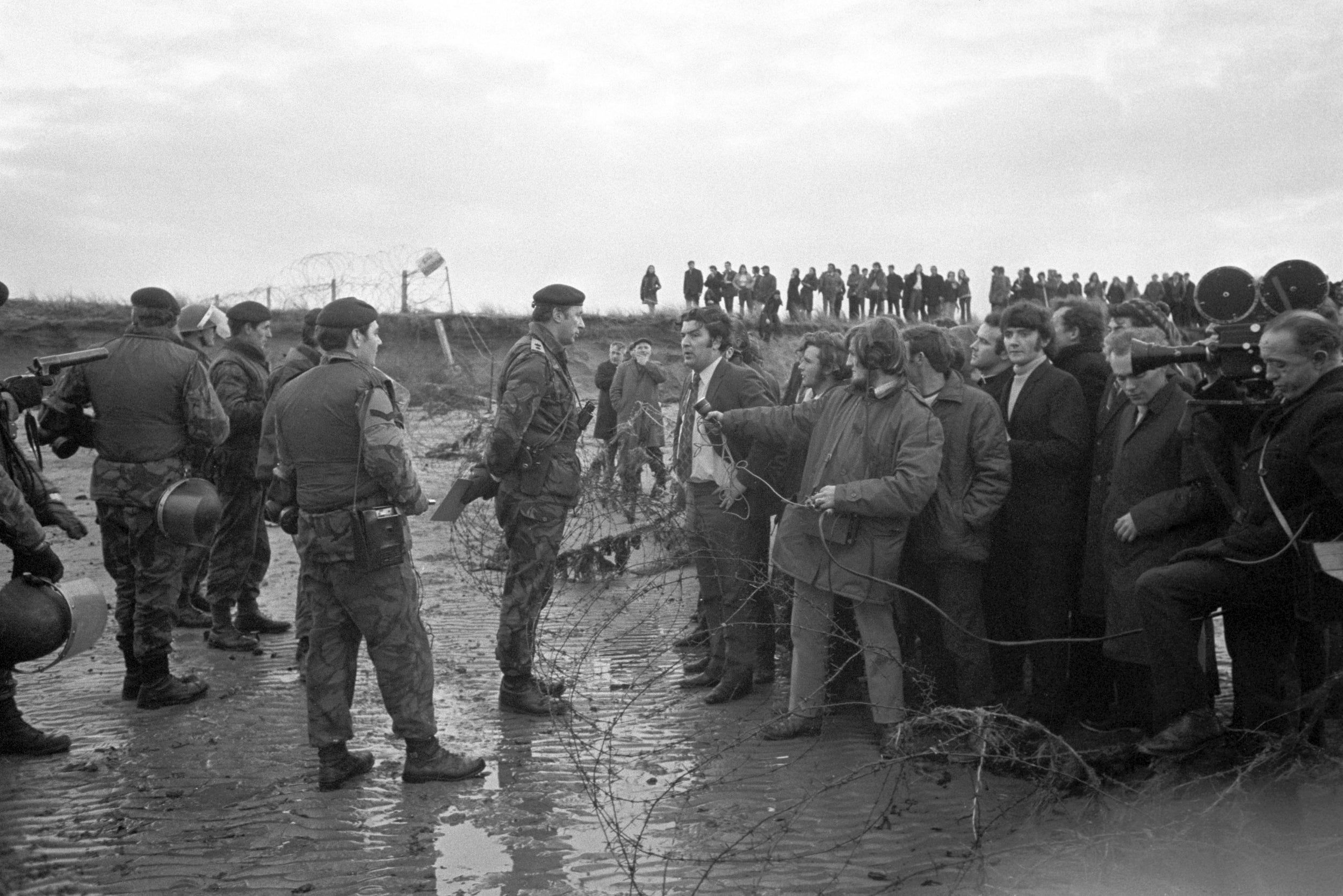 Hume, wearing a white shirt and addressing an army officer, is one of two Stormont MPs who accused the army of brutality towards marchers in an anti-internment demonstration