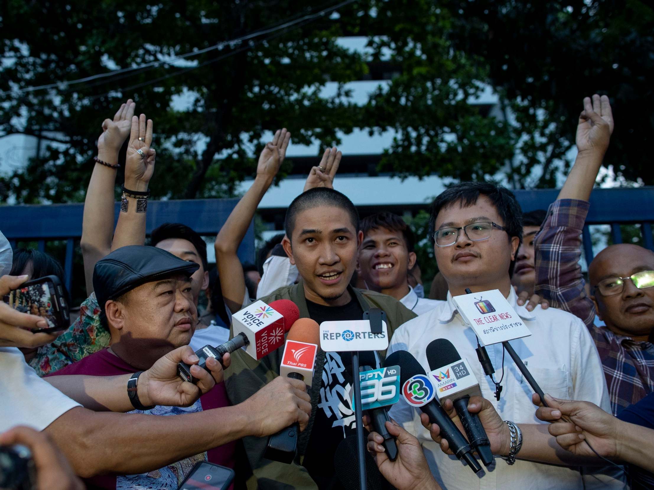 Pro-democracy activist and singer Dechathorn Bamrungmuang speaks outside the criminal courthouse in Bangkok yesterday