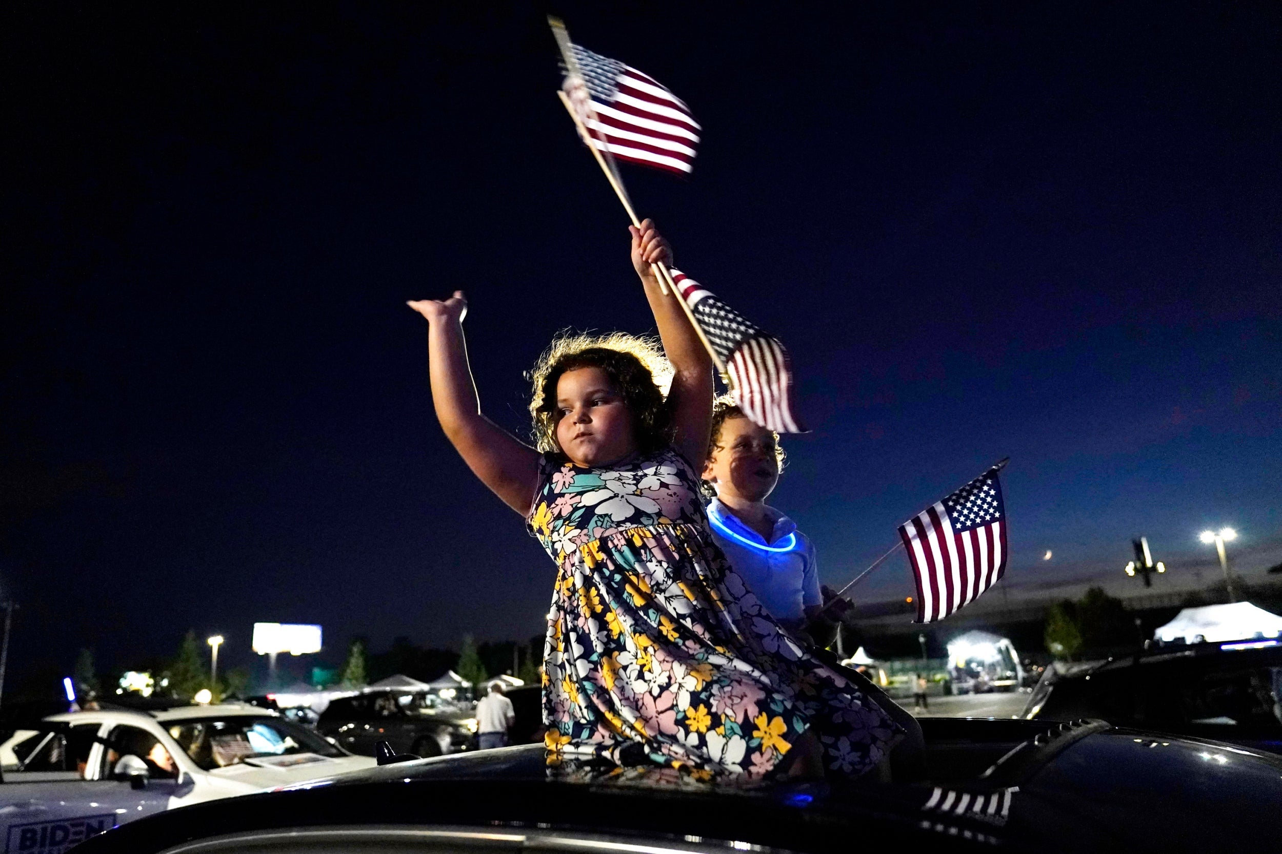 Alessandra Goldstein , 6, and Jonah Goldstein, 8, of Wilmington, Delaware, and their parents, gather with other supporters of Democratic presidential candidate former Vice President Joe Biden gather to watch Biden accept the nomination during the fourth day of the Democratic National Convention, on 20 August, 2020