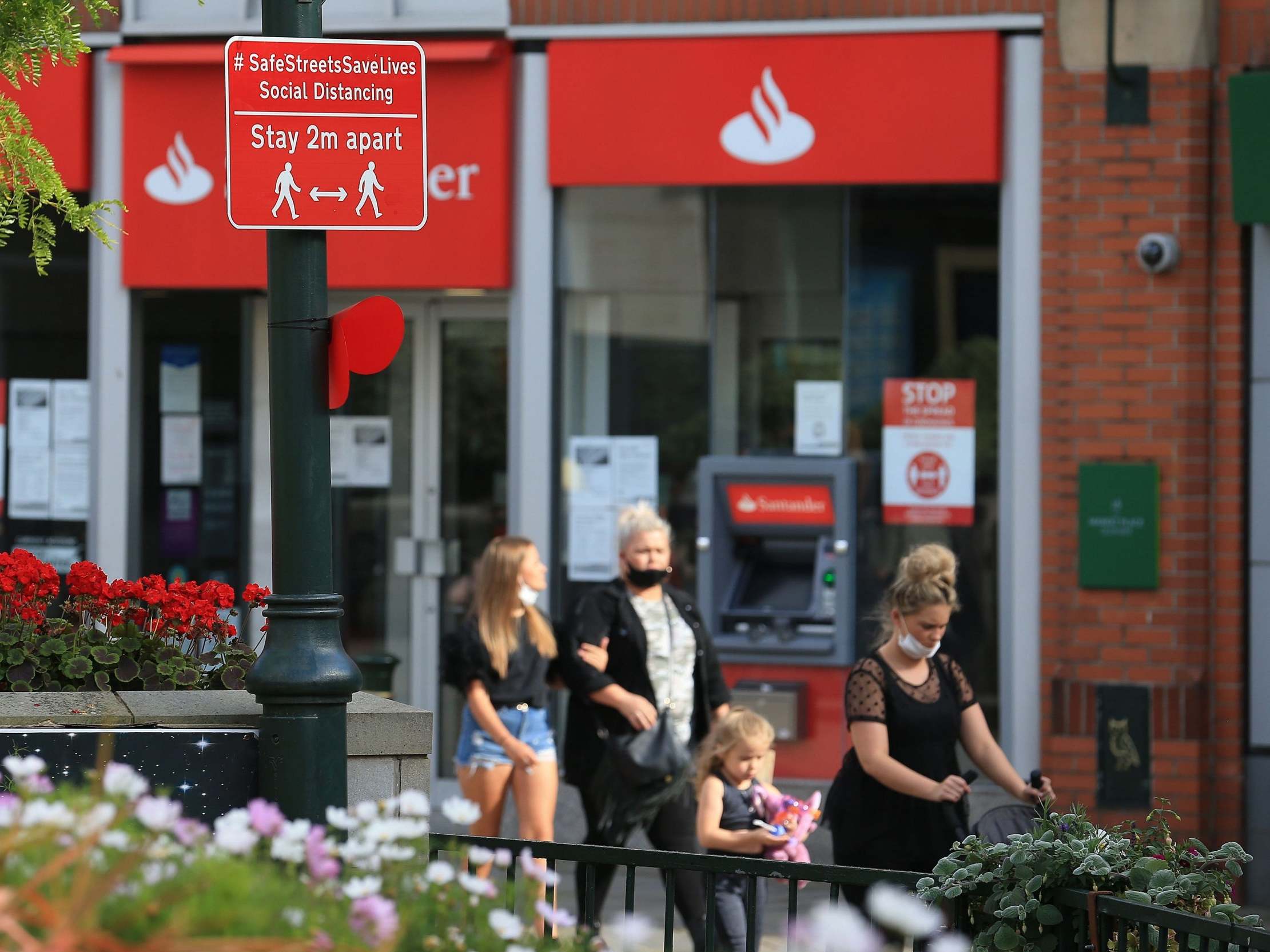 A sign asks pedestrians to keep their distance in Oldham, Greater Manchester