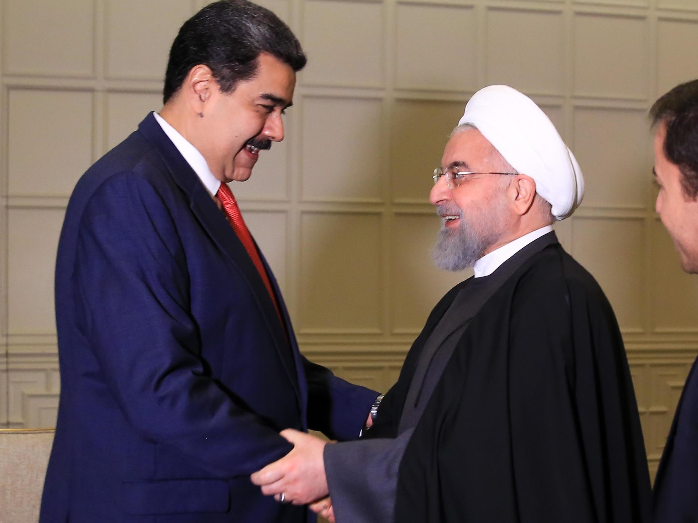 Nicolas Maduro shakes hands with Iran's president Hassan Rouhani before a bilateral meeting in Baku in October 2019