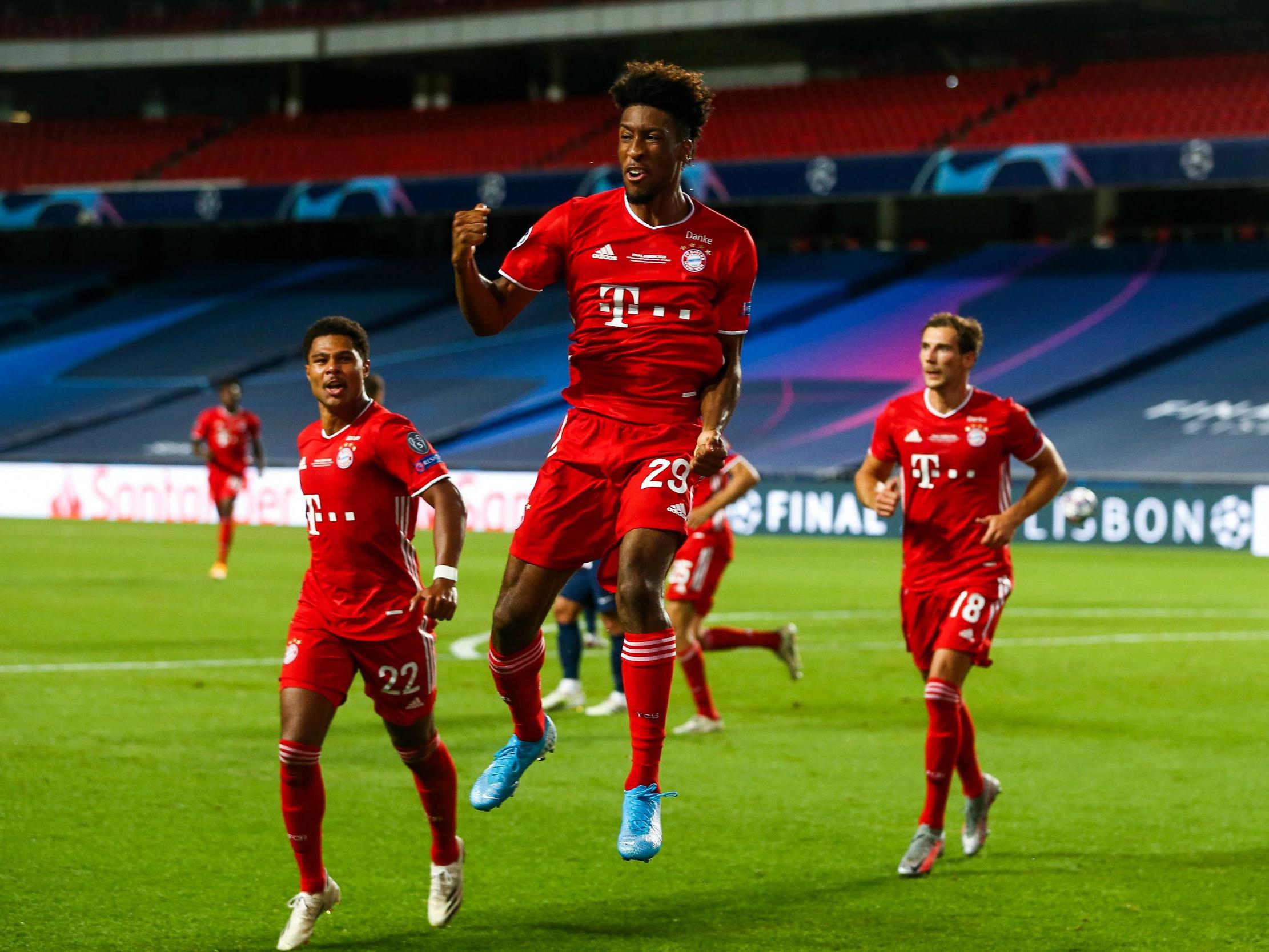 Bayern Munich’s Kingsley Coman (C) celebrates after scoring