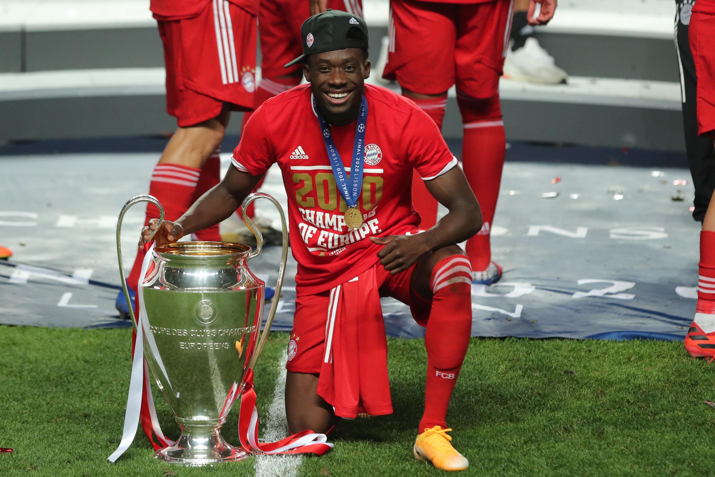 Alphonso Davies celebrates with the Champions League trophy