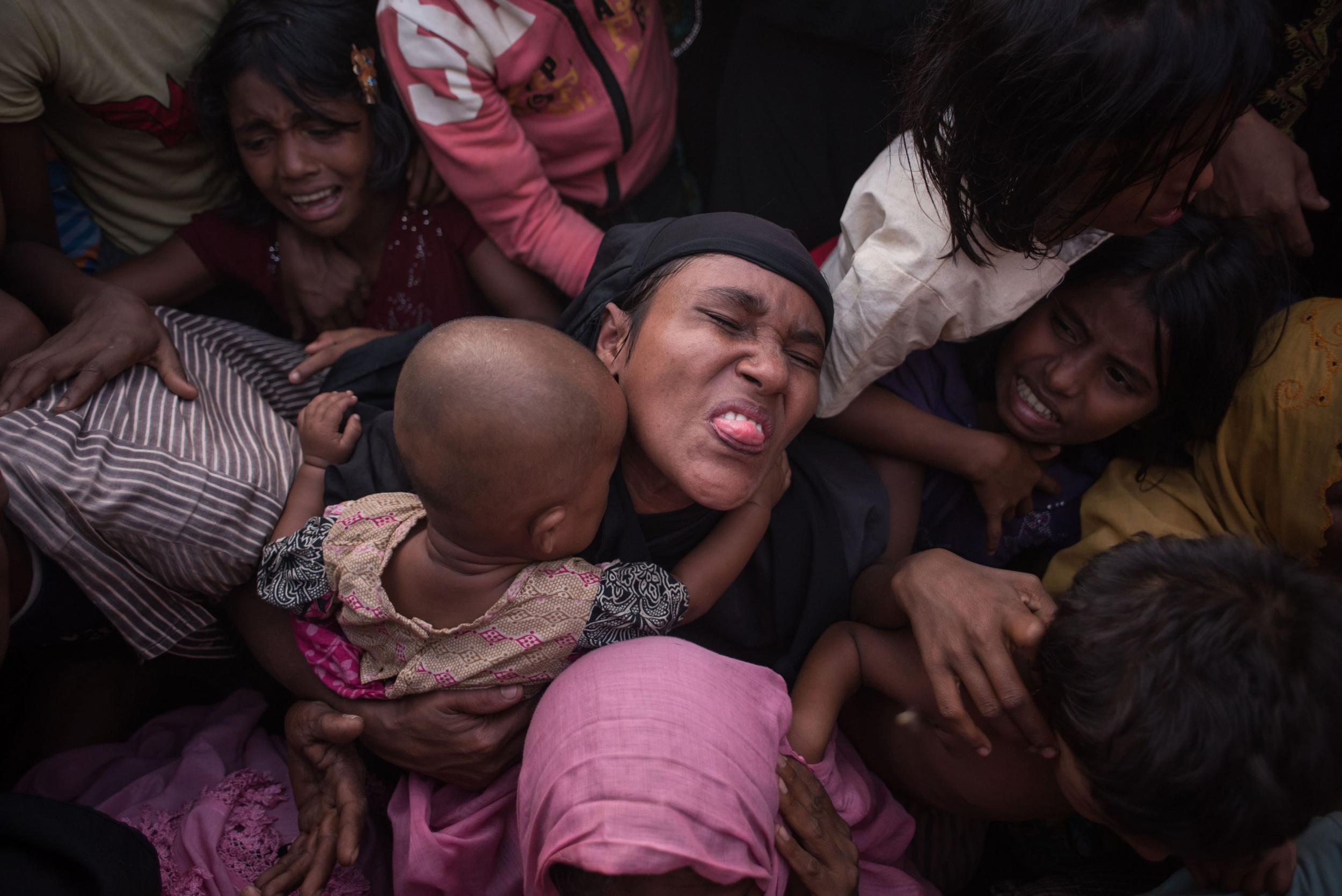 Rohingya refugees are kettled as police attempt to control a surging crowd at a food aid distribution point in Cox’s Bazaar (AFP/Getty)