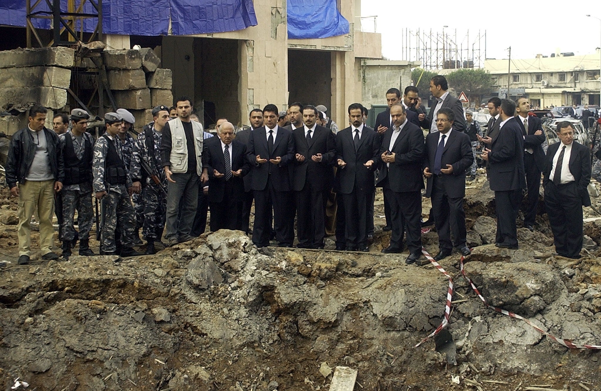 Ayman, Saad, and Bahaa Hariri gather with other mourners at the site of the massive explosion that killed their father in Beirut in 2005 (AFP/Getty)