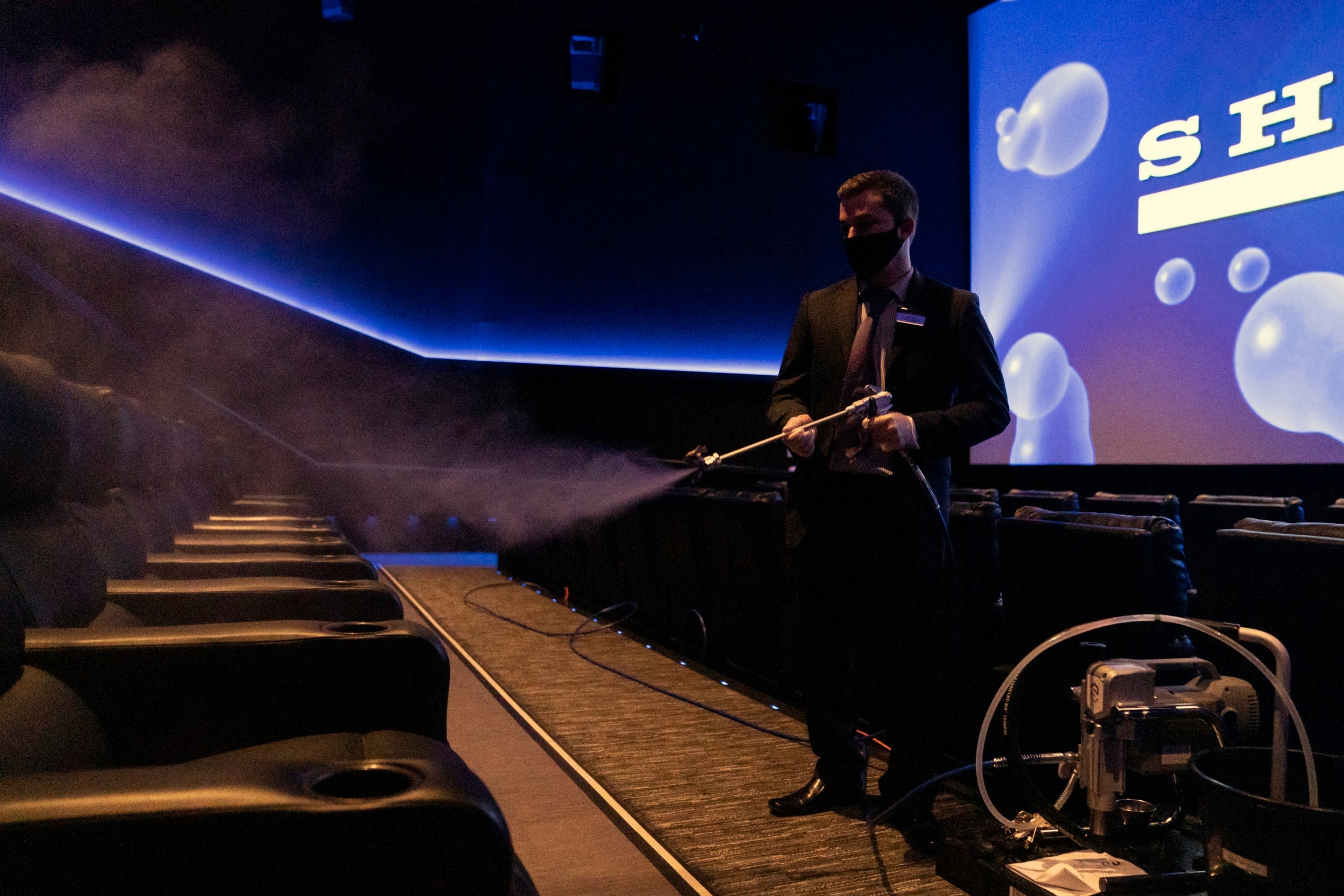 Staff clean the seats at Showcase Cinema in Dartford after the chain reopened on 4 July