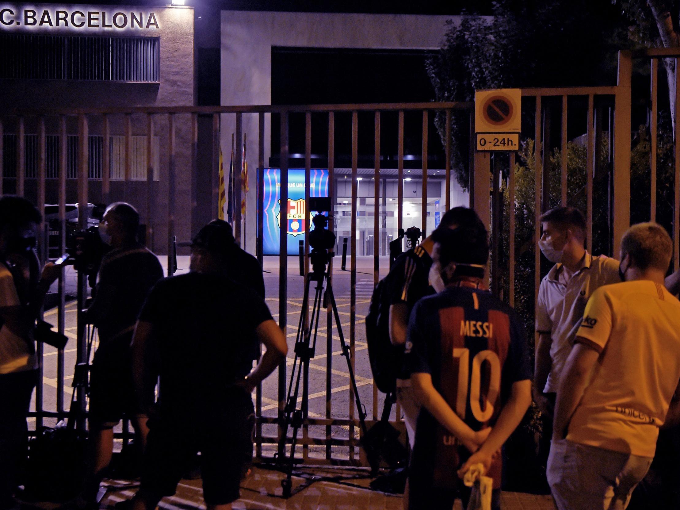 Barcelona fans and journalists gather at the Nou Camp after Lionel Messi announces his desire to leave