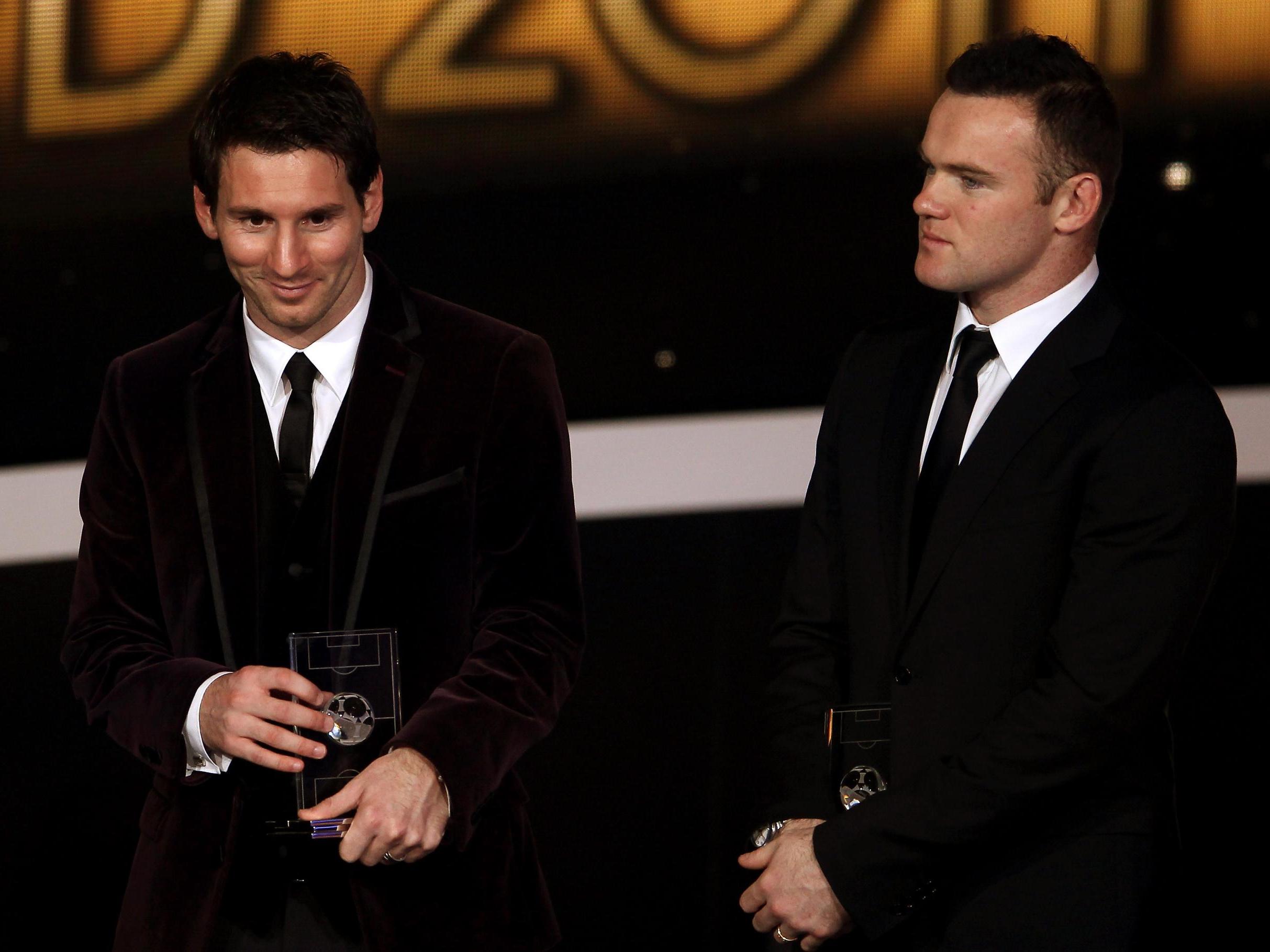 Lionel Messi of Barcelona (L) with Wayne Rooney of Manchester United