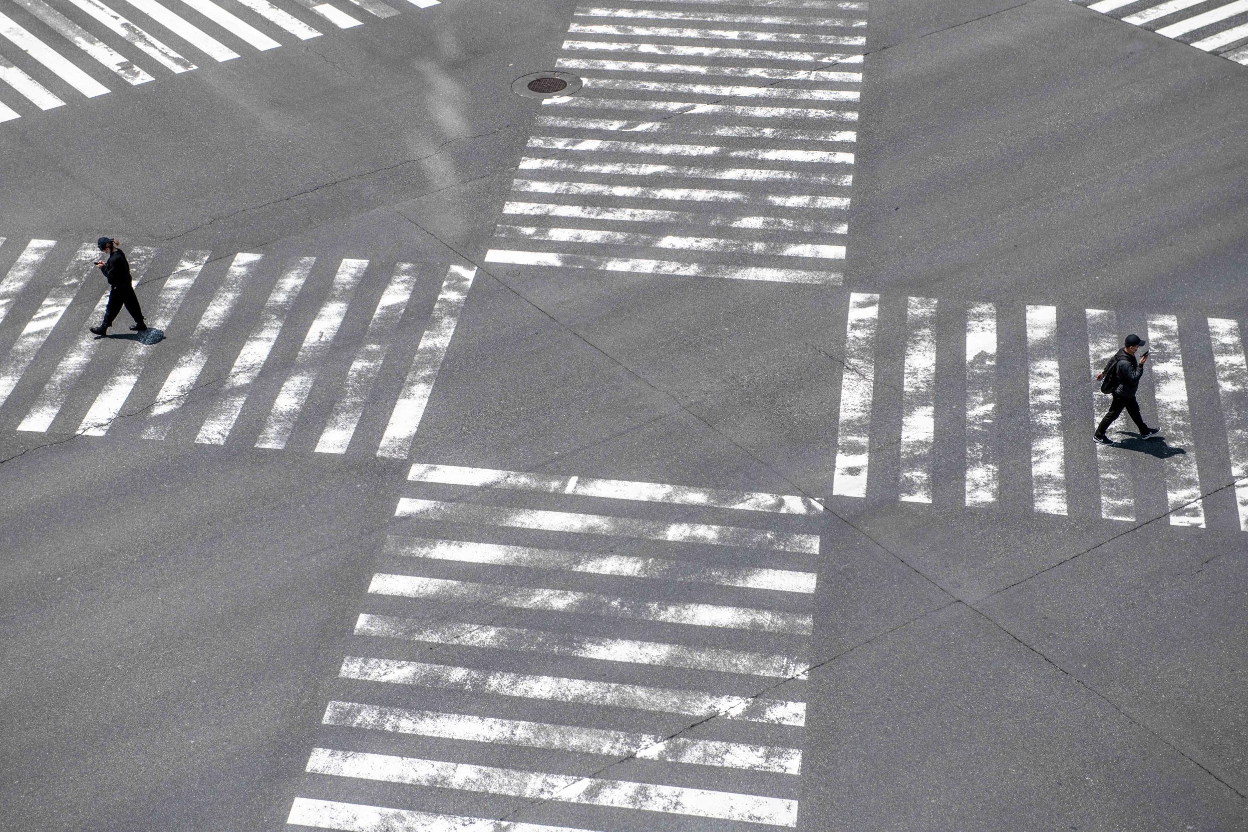 Pedestrians walk over a crossing in Ginza, Tokyo, during April’s nationwide state of emergency in Japan