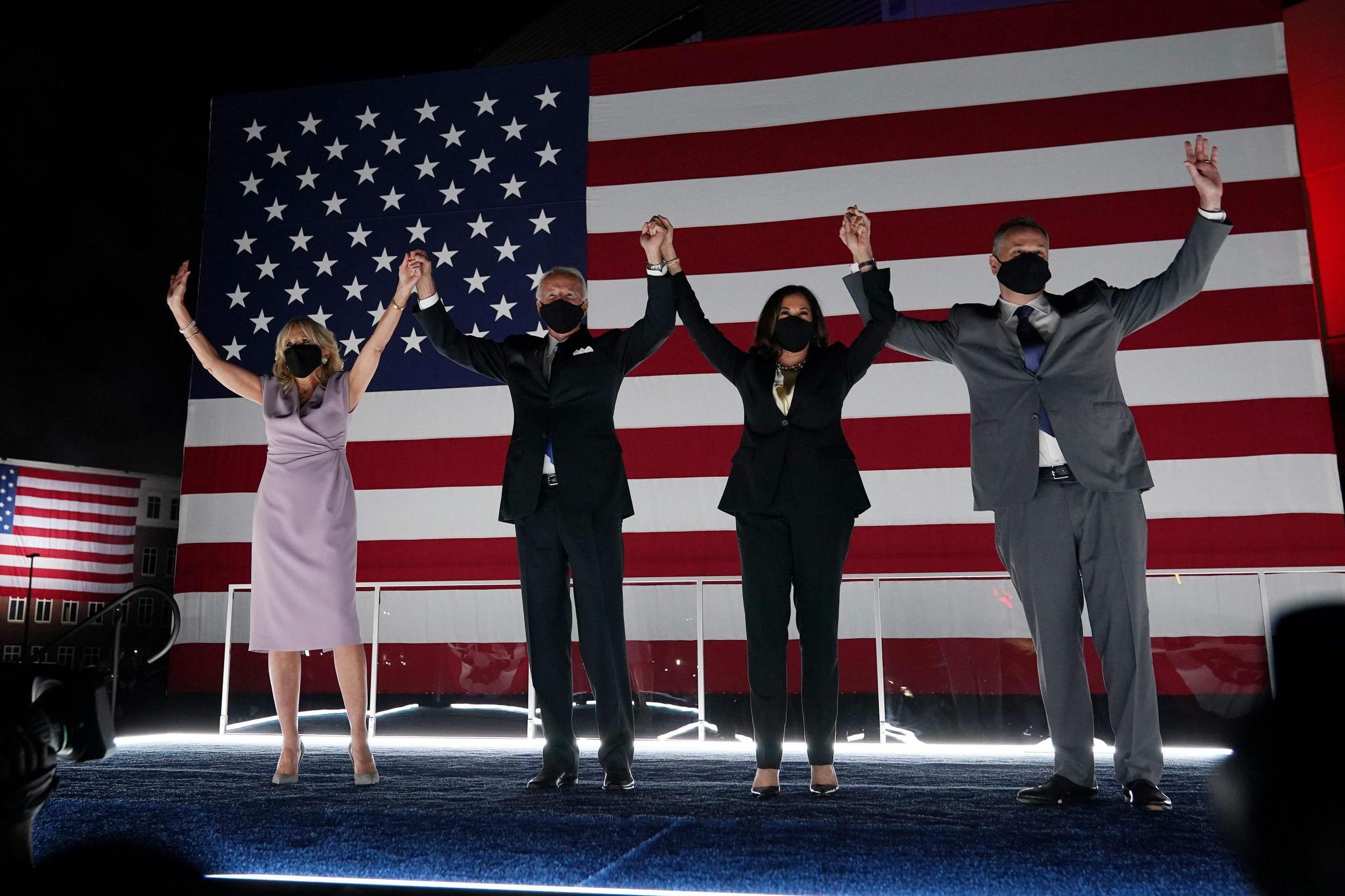 Joe Biden and Kamala Harris, centre, on stage at the Democratic National Convention, with their partners (AFP/Getty)