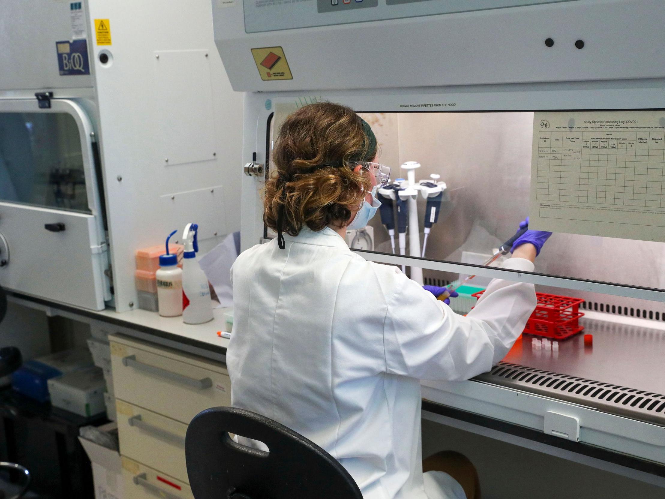 A scientist working on the coronavirus vaccine at a laboratory facility at Churchill Hospital, Oxford (A