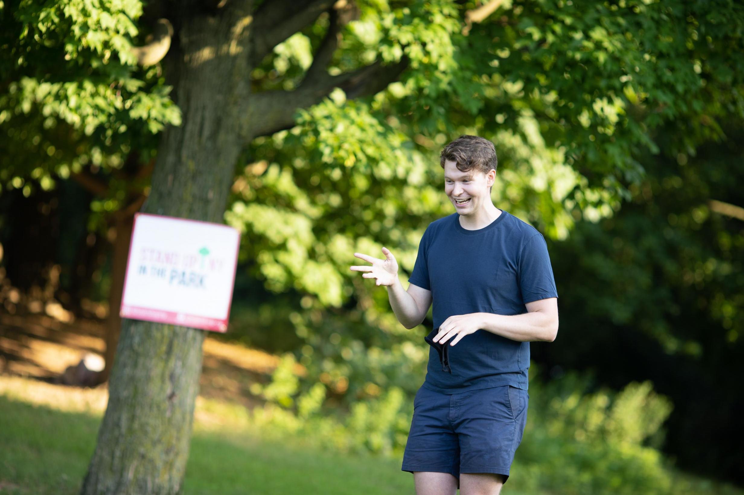 Zach Zimmerman performing stand up in the park