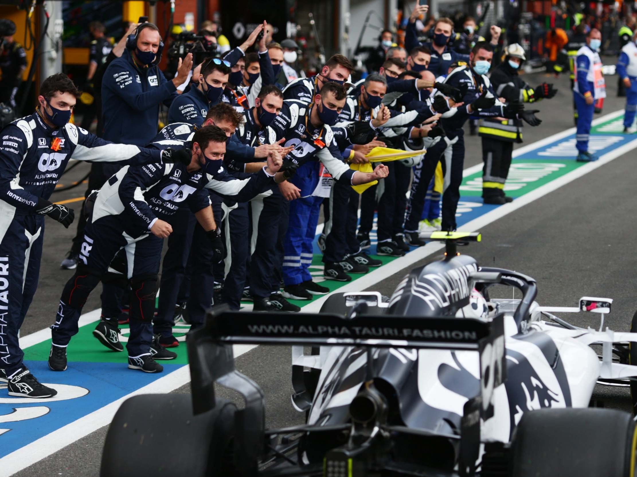 The AlphaTauri team congratulate Pierre Gasly on his return to the pits