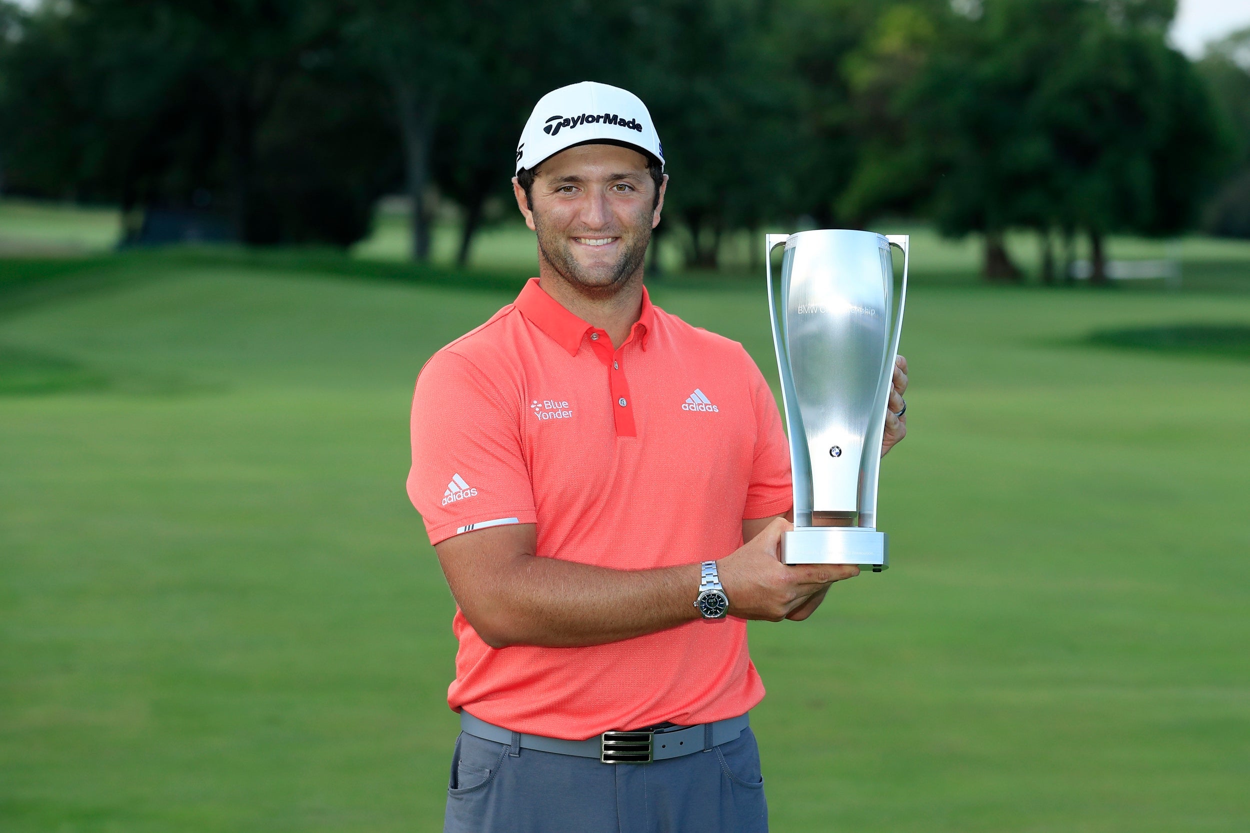 Jon Rahm celebrates with the BMW Championship trophy