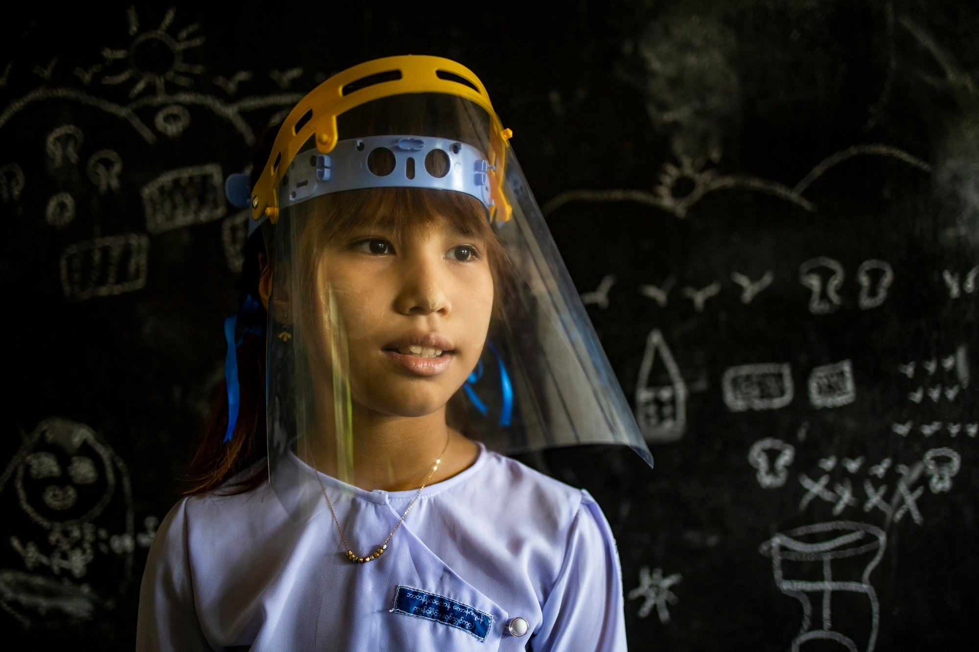 Mon National Post Primary School student Mi A Mee Taw, wearing a visor in class