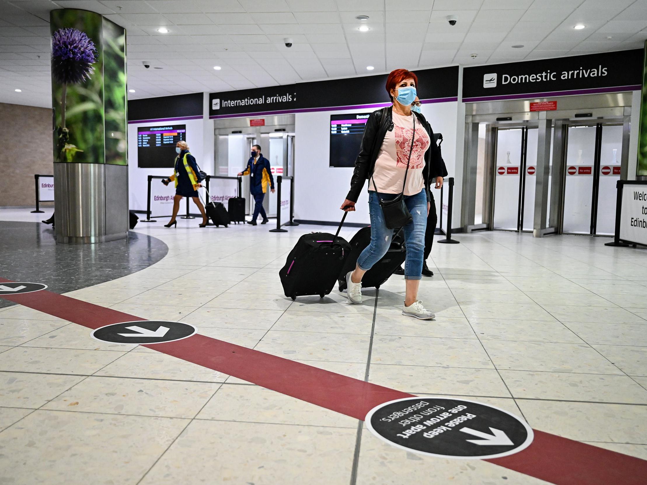 Passengers make their way through the main terminal at Edinburgh Airport on July 07, 2020