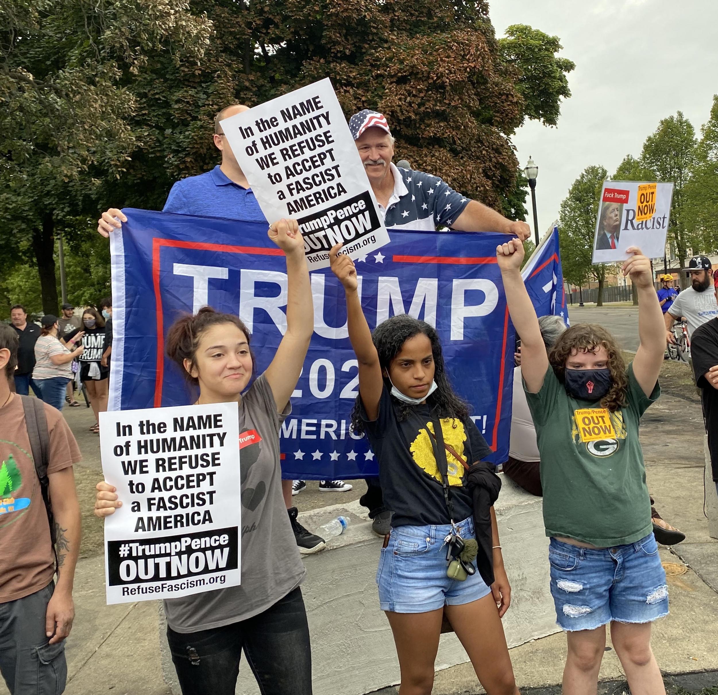 Protesters stand in front of Trump supporters during the president’s visit to Kenosha, Wisconsin (Richard Hall / The Independent )