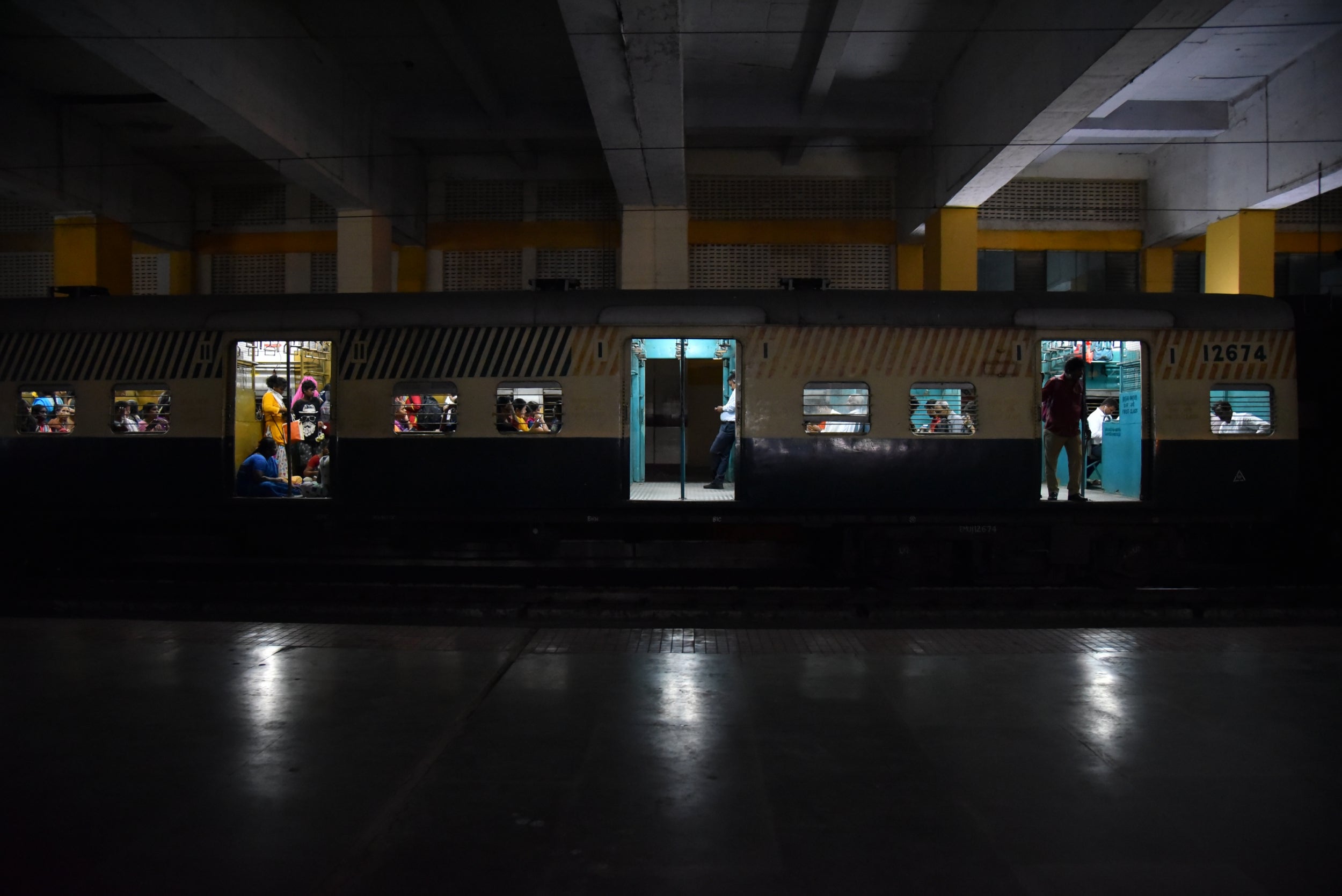 Limited lighting as a train waits at a platform