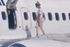 Woman opens emergency exit and climbs onto plane wing after feeling too hot on flight