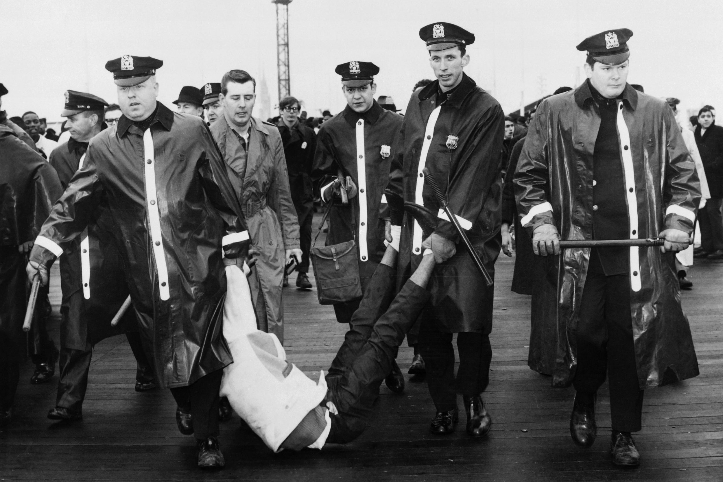 Police detaining – with force – a man who was lying on the ground during the New York Fair in 1964 to protest against racial equality