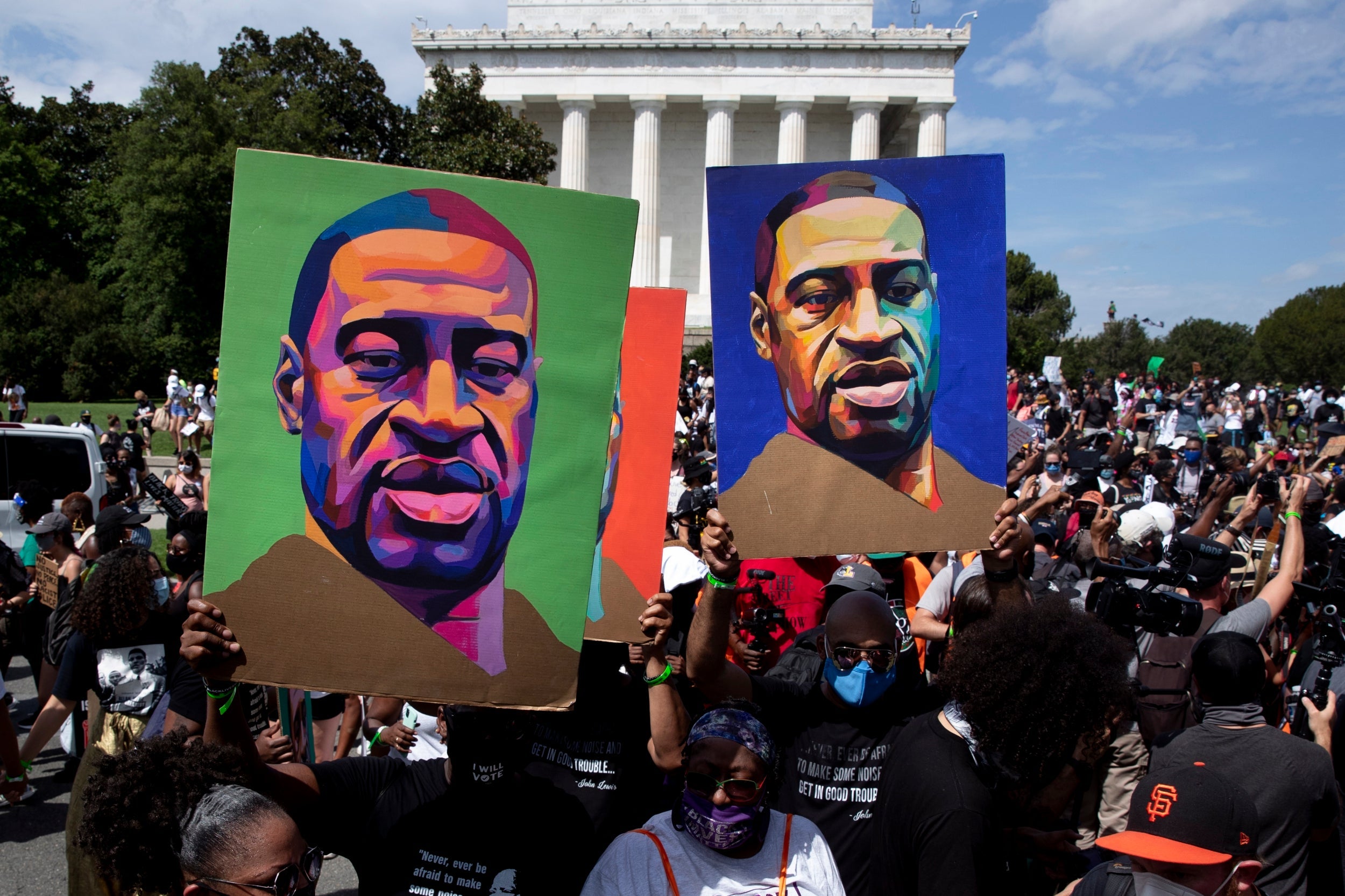 Placards of George Floyd held aloft during the ‘Commitment March: Get Your Knee Off Ours Necks’ in Washington DC last month