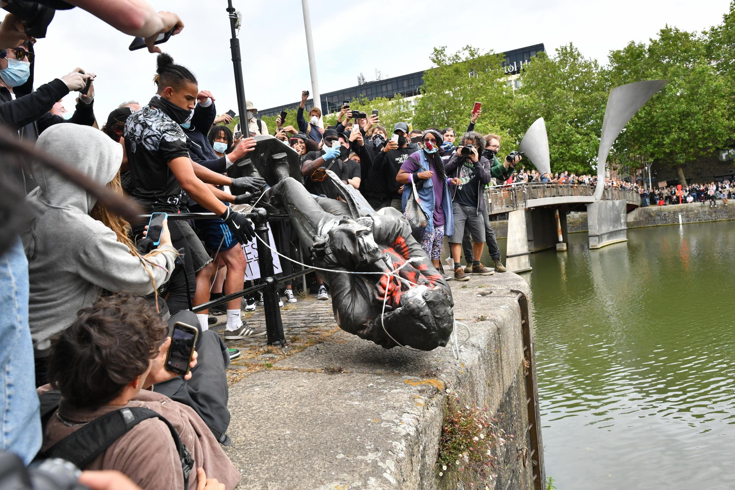 Protesters throw the statue of Edward Colston into Bristol harbour