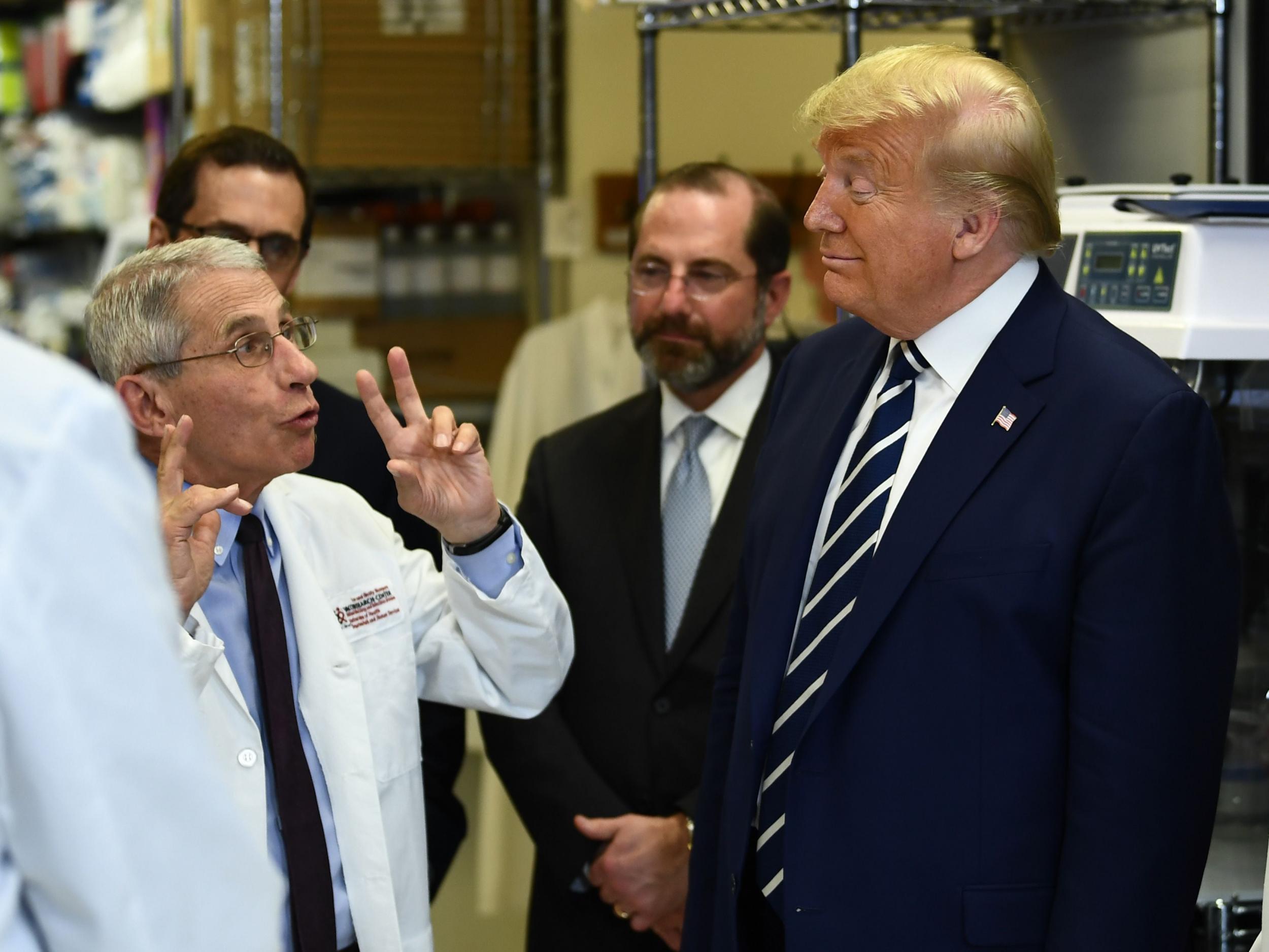 Anthony Fauci (left) and Donald Trump (right) speak. Fauci writes in a new book that Trump went on an expletive-filled rant directed at him during the pandemic