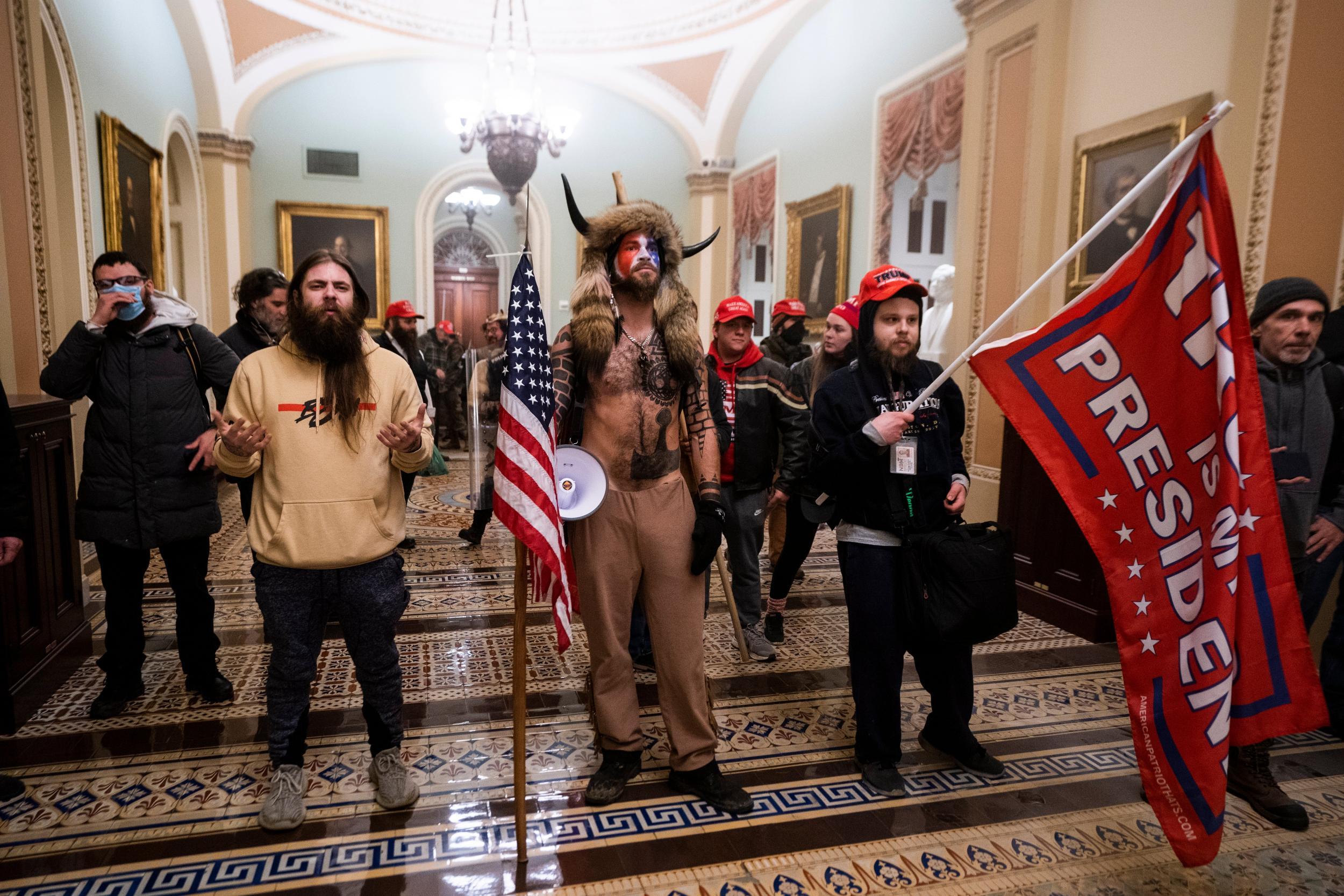 Jacob Chansley, centre, who prosecutors believe had deadly intent during the riot