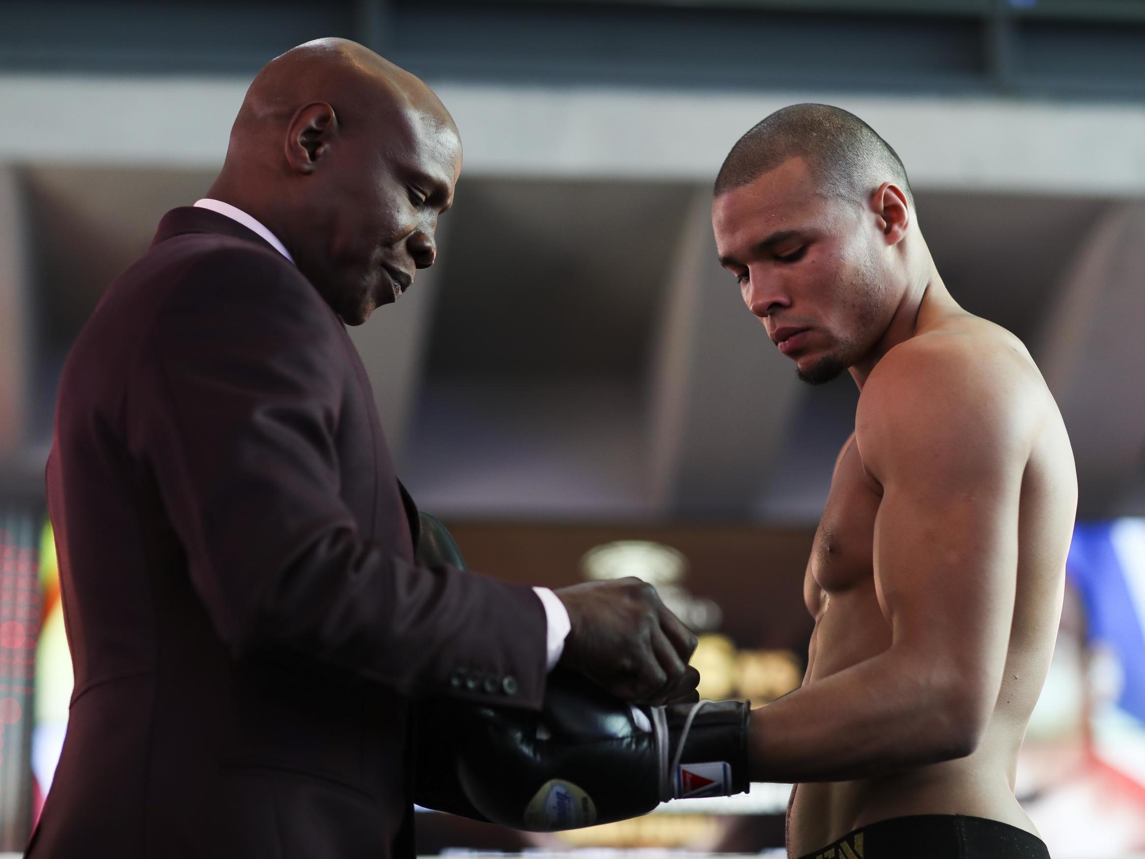 Chris Eubank Sr laces his son’s gloves
