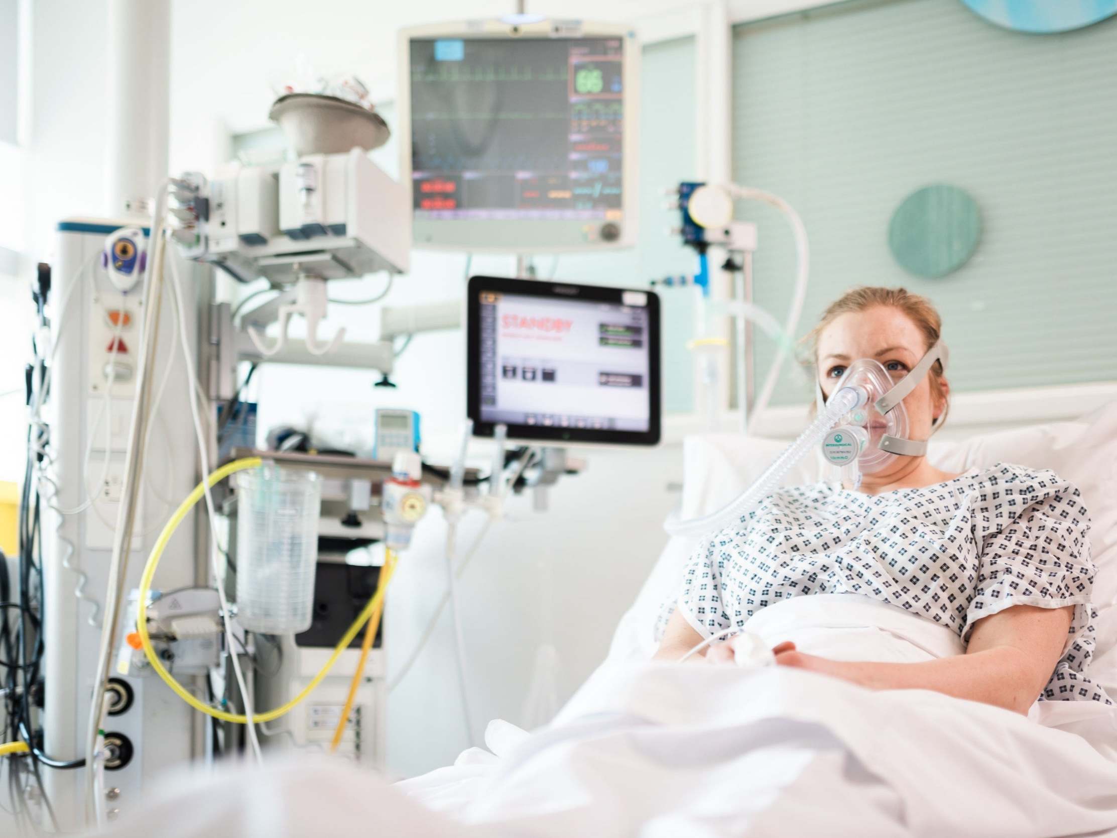 A volunteer demonstrates a ‘continuous positive airway pressure’ machine, or CPAP