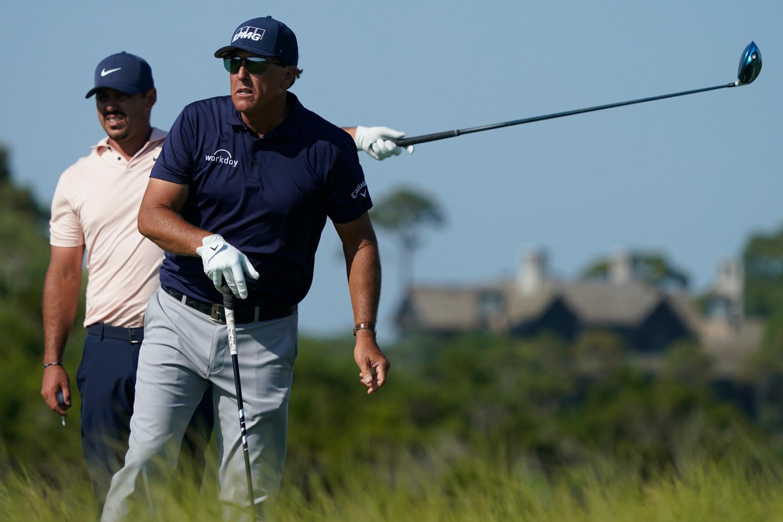 Phil Mickelson and Brooks Kopeka, left